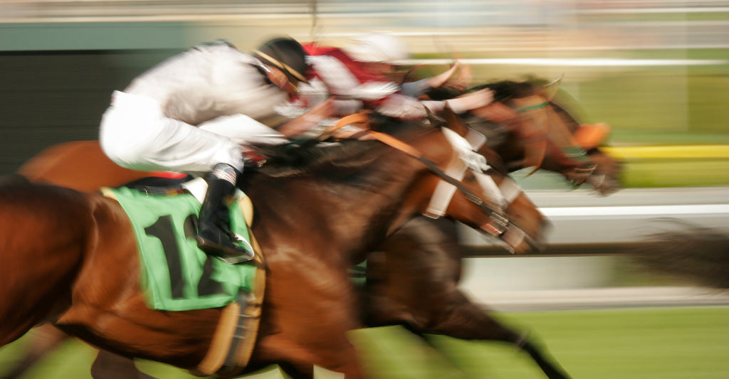 blurred image of racehorses