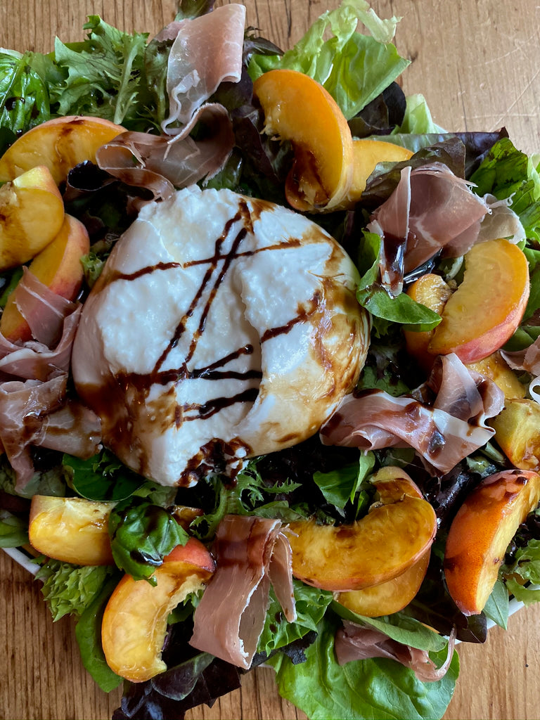 Buratta and Peach Salad with prosciutto, spring mix, basil, olive oil and balsamic glaze 
