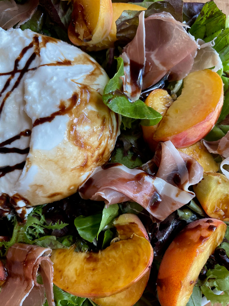 Buratta and Peach Salad with prosciutto, spring mix, basil, olive oil and balsamic glaze 