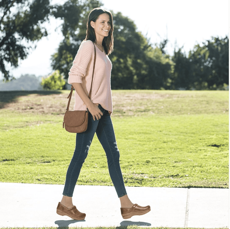 dansko distressed leather clogs