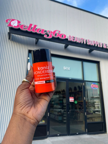 Kaniz hair pomade stick in front of Bella360 Store location in Edmonton