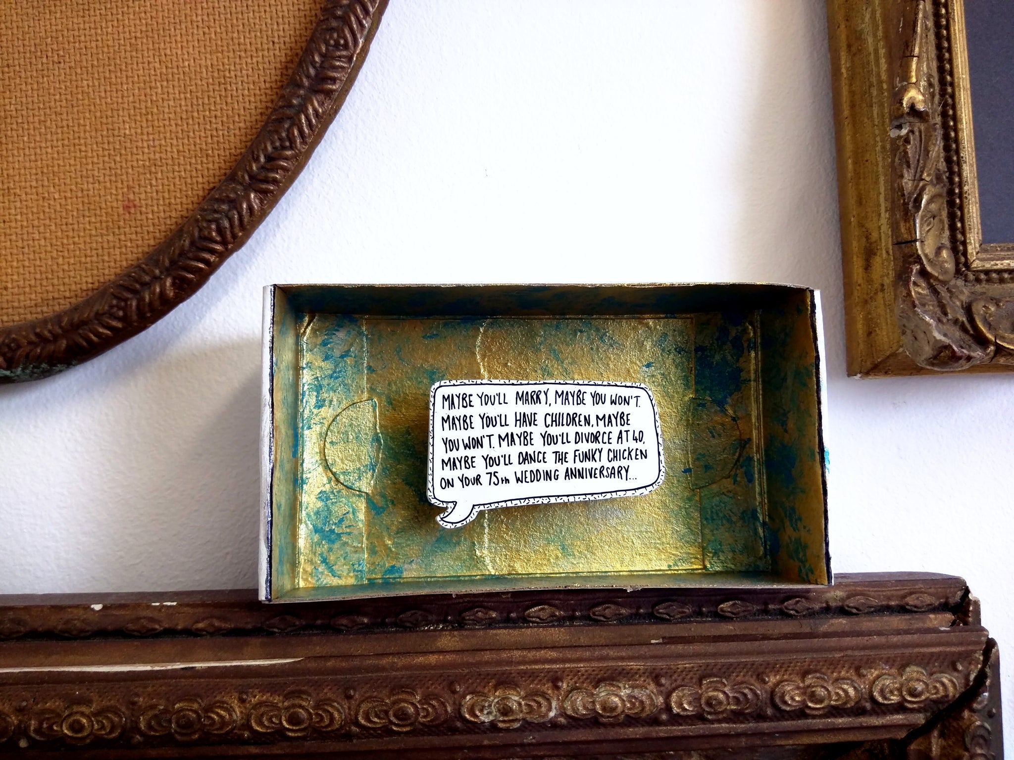 Quote in a speech bubble within a decorated matchbox