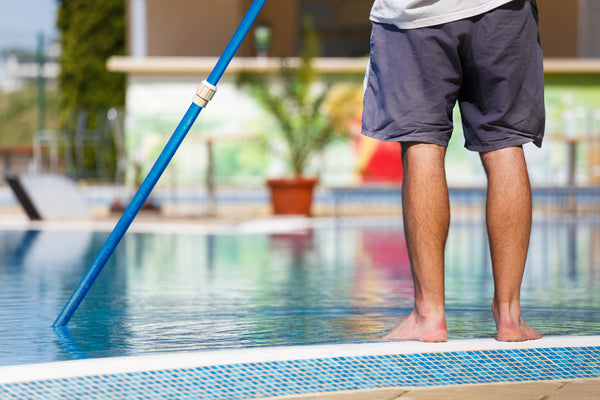 Clean the interior walls of your pool with a pool brush