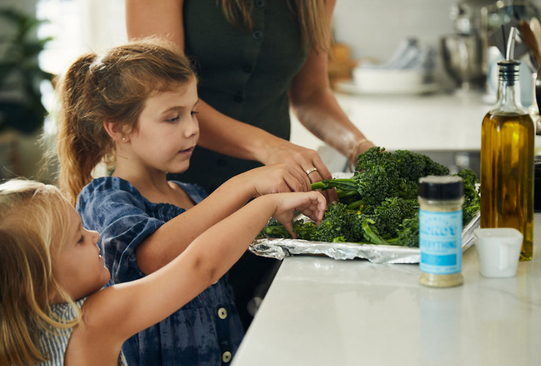 two kids helping their mom in the kitchen with auntie nonos everything seasoning 