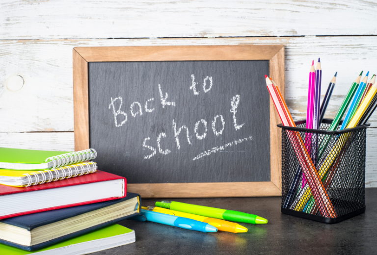 chalkboard with the words "Back to School" surrounded by school supplies. 