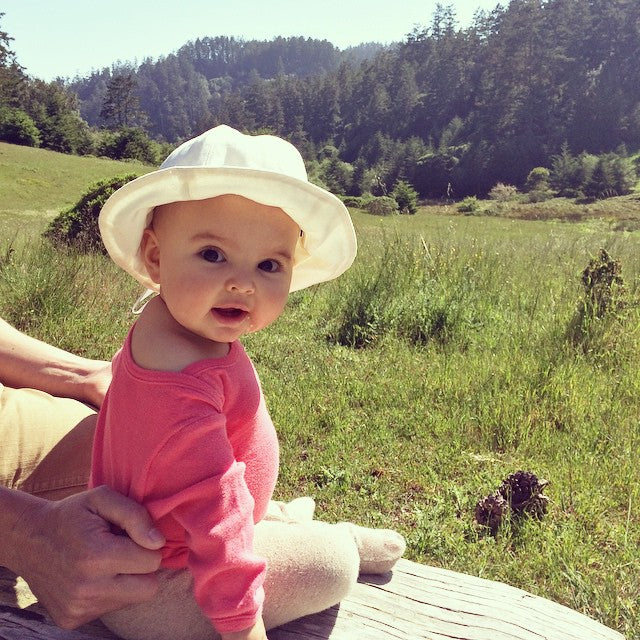 Happy baby in a meadow | @ayabrackett on Instagram
