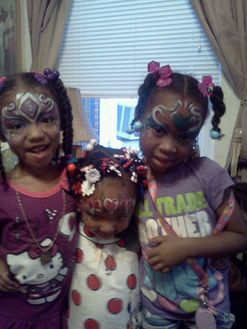 Happy children showing off their favorite face painting designs by Creative Angel Artwork"