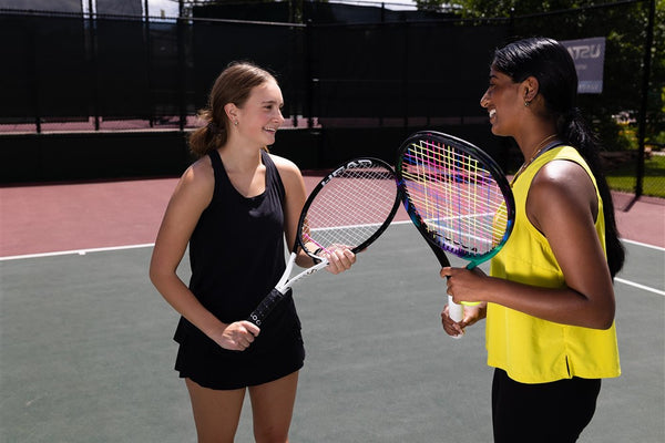 two college players discuss sustainable tennis gear