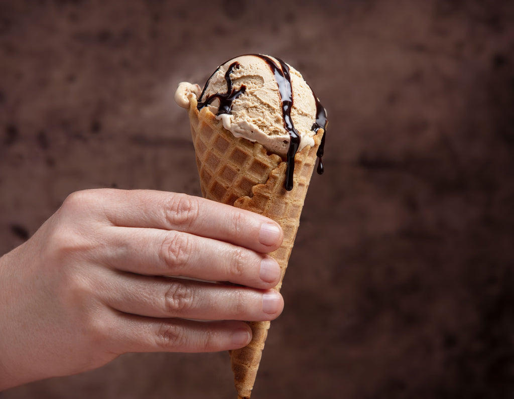 Han holding ice cream cone filled with coffee ice cream.