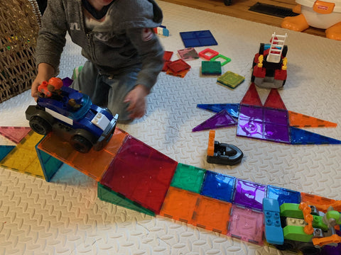 Child playing with Mega Bloks PAW Patrol on carpet