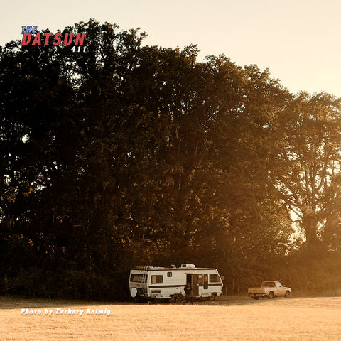 Datsun pickup truck in a field