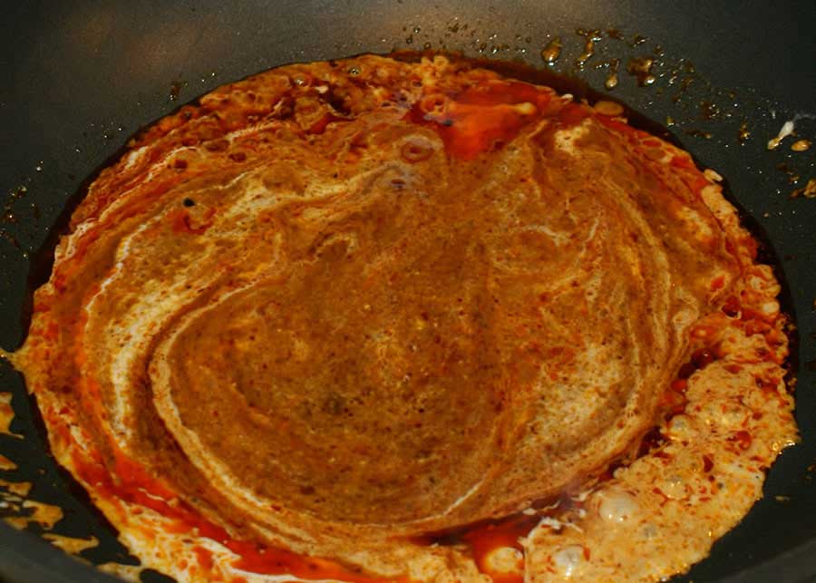 Heat-red-curry-paste-and-coconut-milk-in-pan