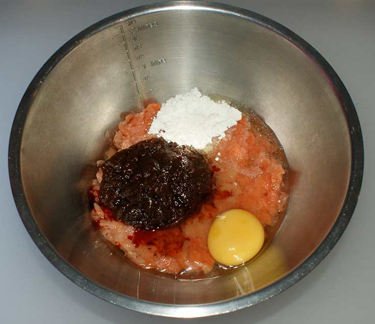 Ingredients for Thai fish cakes in mixing bowl