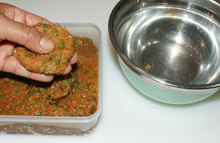 Forming Thai fish cakes.