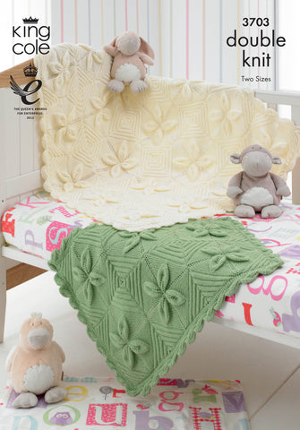 Image of cover of knitting pattern showing two baby blankets knitted in squares with a leaf effect. Shown in cream and green yarns