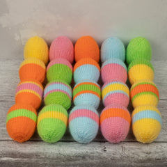 Rows of hand-knitted eggs in yellow, pink, orange, blue and green. There are four designs shown - one and two colours, one and three stripes