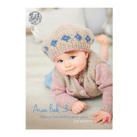 Image of cover of King Cole Aran Book 3 knitting pattern book featuring a baby wearing a hand-knitted Aran outfit including a cute hat