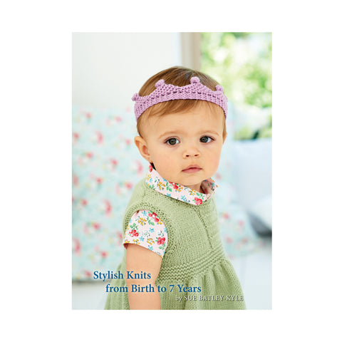 Image of cover of baby knitting book 7 featuring a baby wearing a knitted green dress and pink tiara