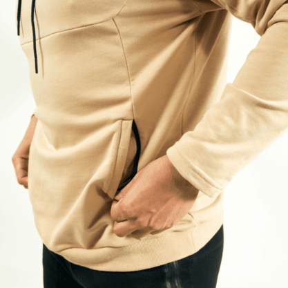 Man putting his hands into the zipper pockets of one of the best gym hoodies for men from Lone Wolf Fitness