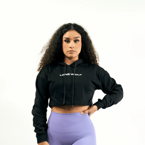 Female model wearing Lone Wolf Fitness black athletic hoodie and purple leggings 