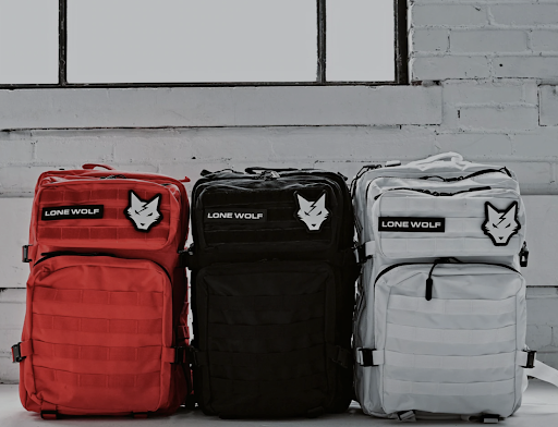 red, black, and grey workout backpacks lined up