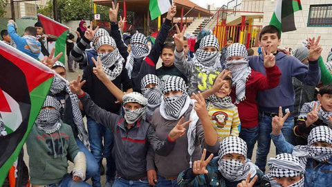 people celebrating keffiyeh day rajaeen