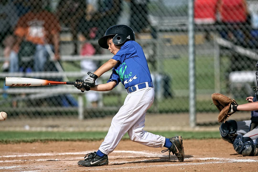 Child swinging a baseball bat