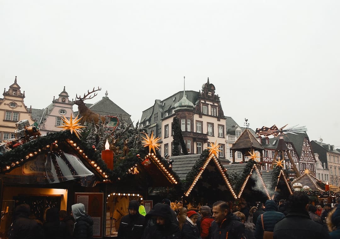 People wandering a market in Germany at Christmas time