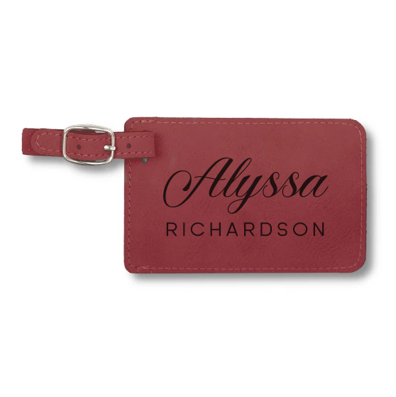 A red luggage tag with a name engraved on it