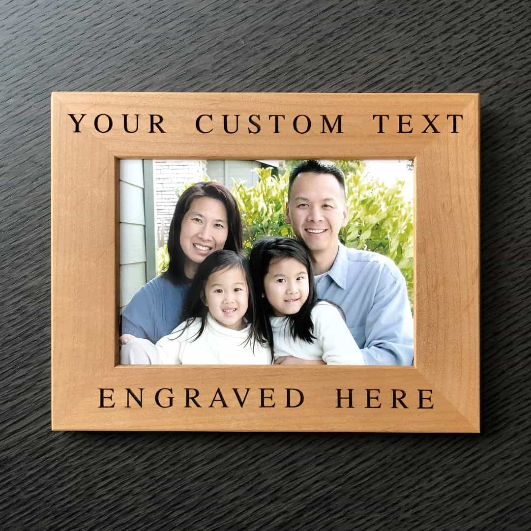 An engraved picture frame with a family photo