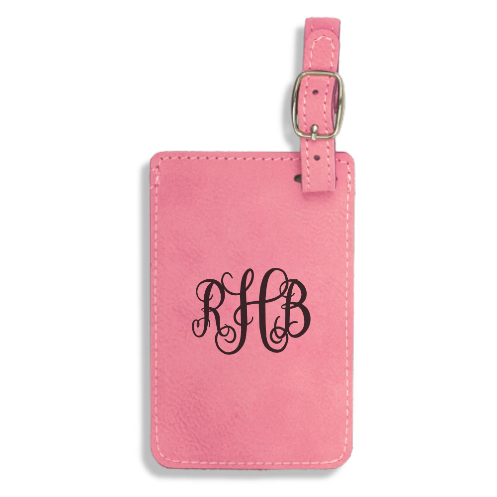 A pink luggage tag with monogrammed initials