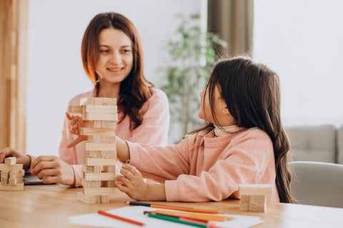 Mother and daughter playing Jenga