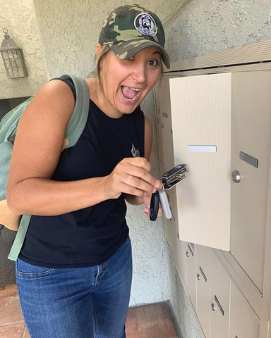 Happy Keyporter opening her mailbox with her Keyport Pivot 2.0 key organizer multi-tool