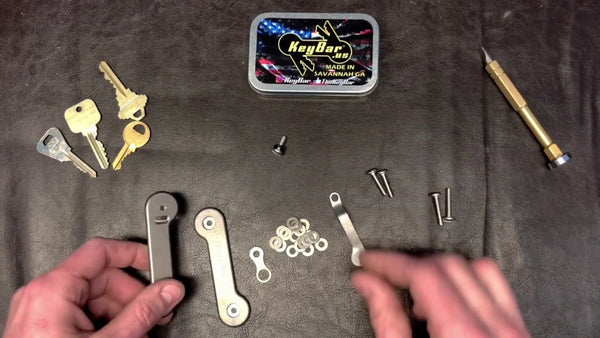 Assembling two-sided key organizer has many parts