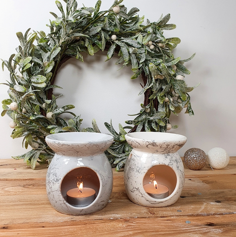 Two Ceramic Oil Burners with a lit candle inside.