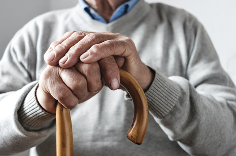 elderly man holding cane