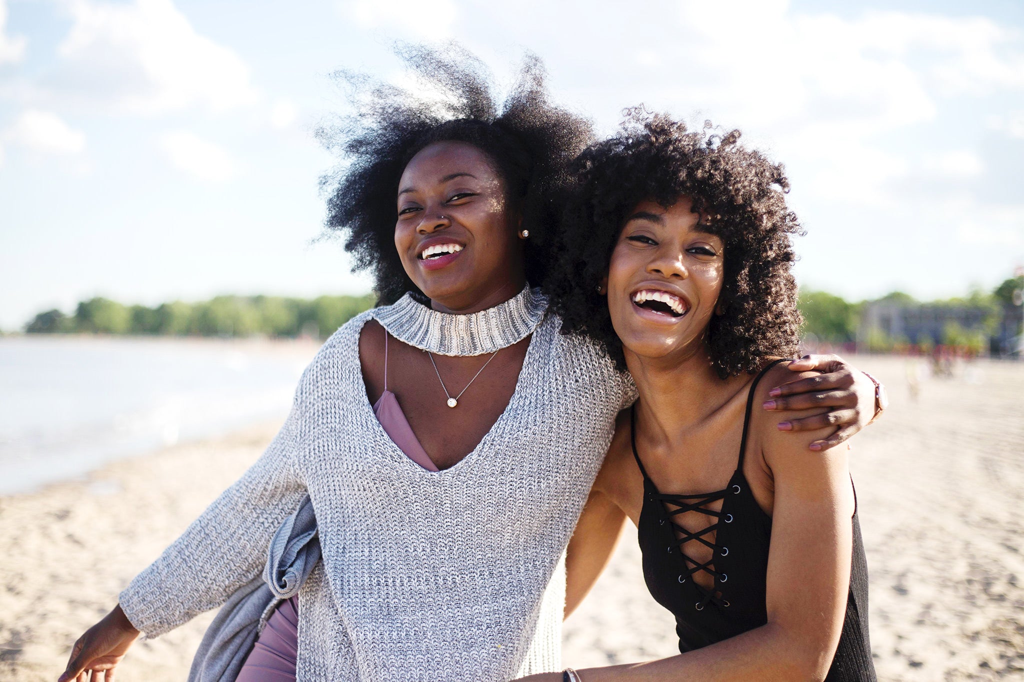 two women in the sin on the beach. 