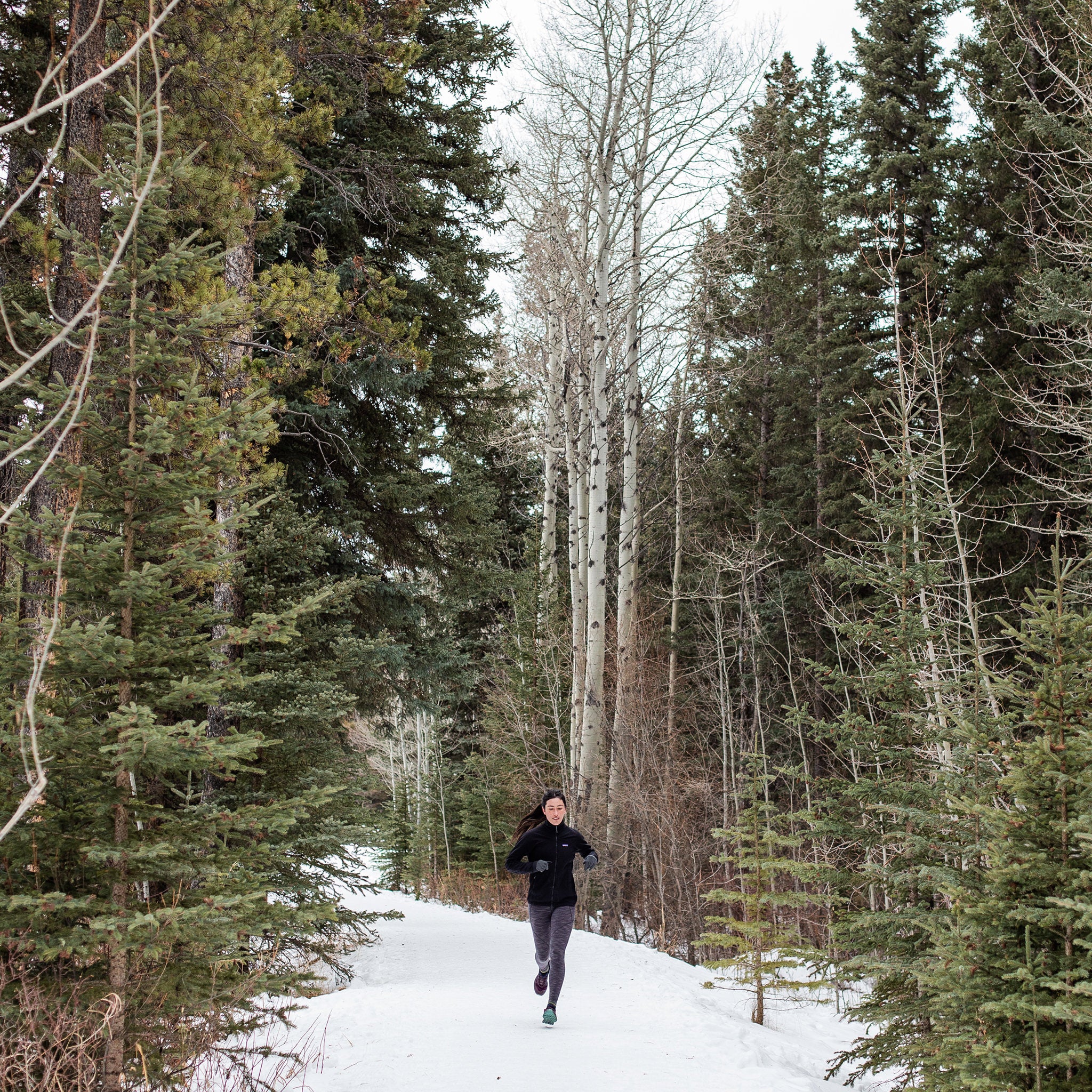 image of woman running in woods