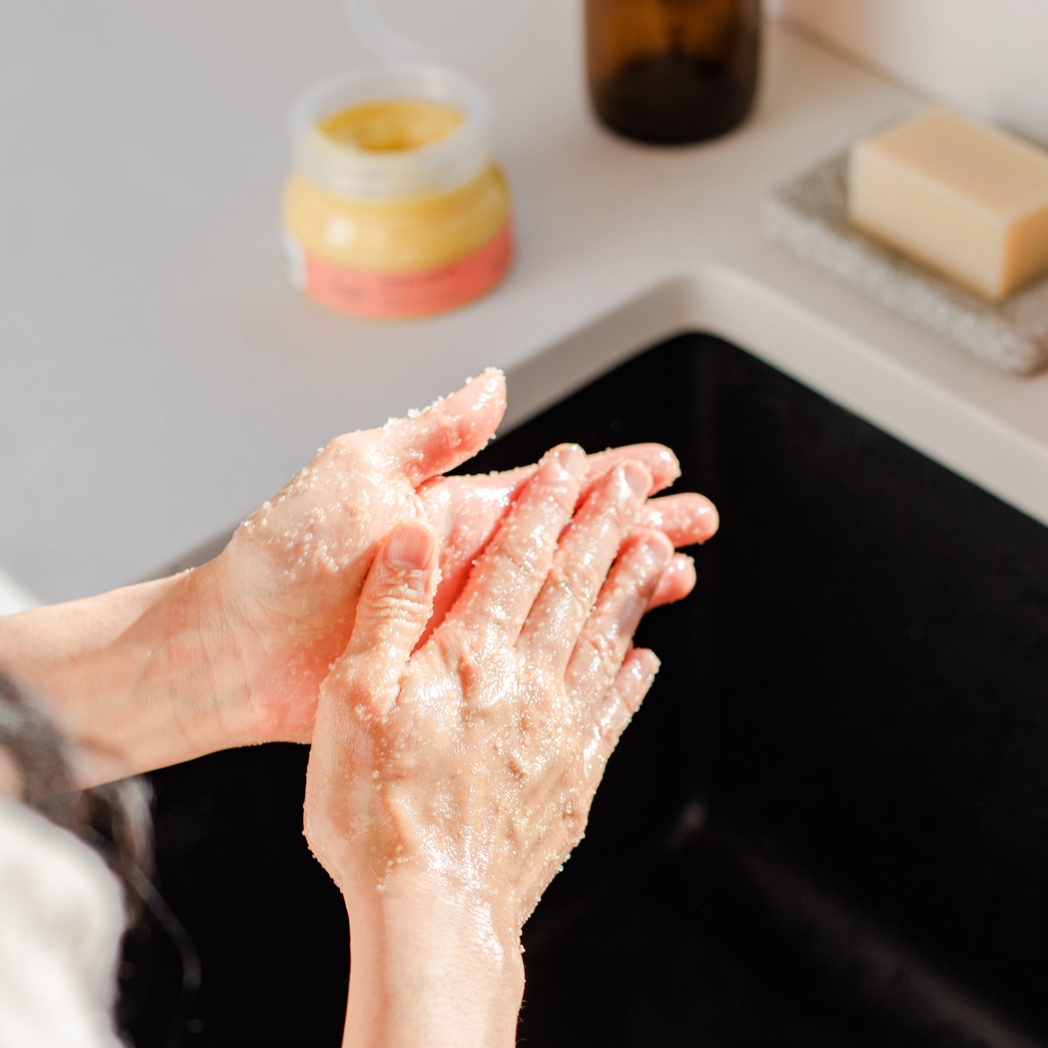 Image of all natural hand scrub being used to exfoliate hands. 
