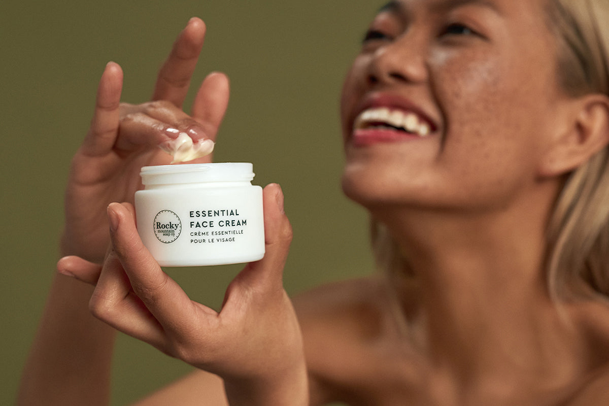 Image of woman using natural face cream that's made in Canada by rocky mountain soap company. 