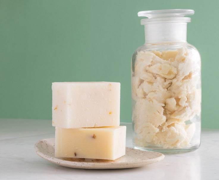 natural bar soap with a jar of shea butter