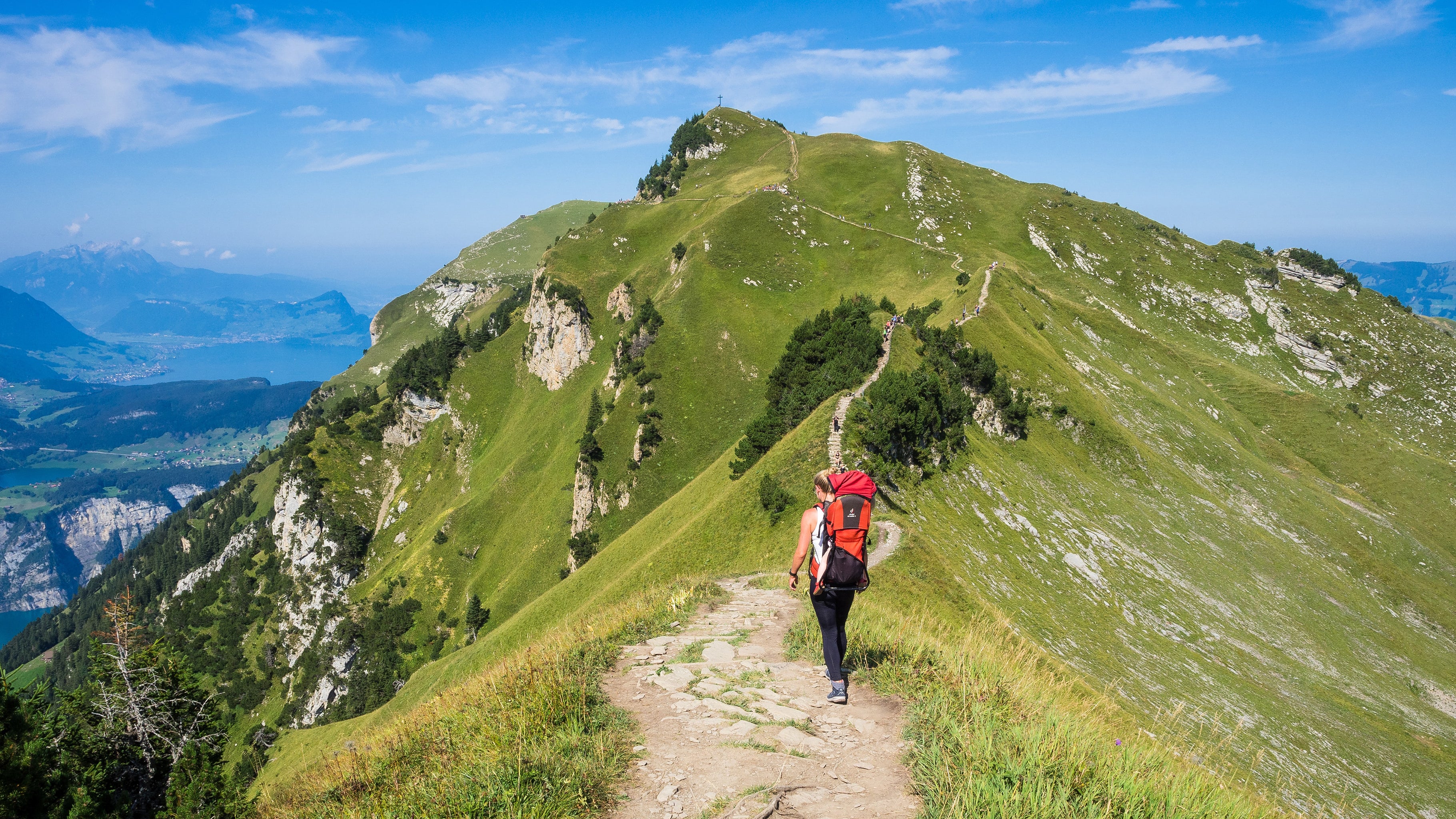 Image of woman hiking alone on a mountain trail. 