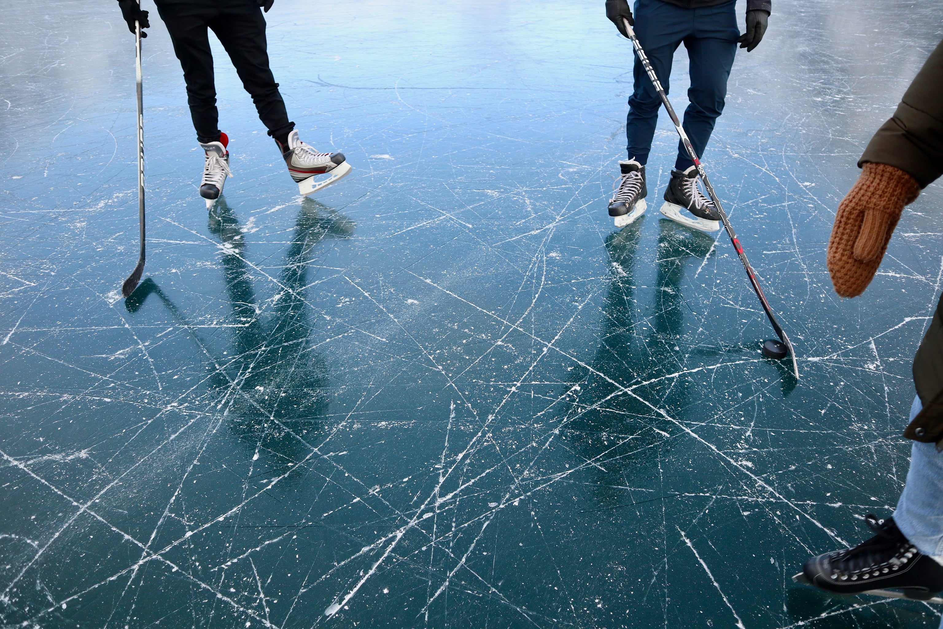 image of ice skates on frozen lake. 