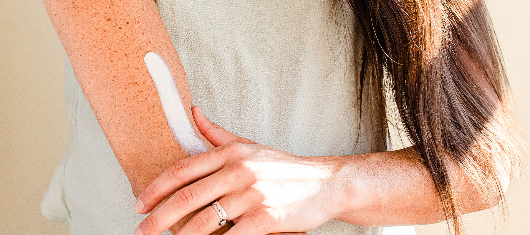 Image of natural sunscreen being applied to an arm. 