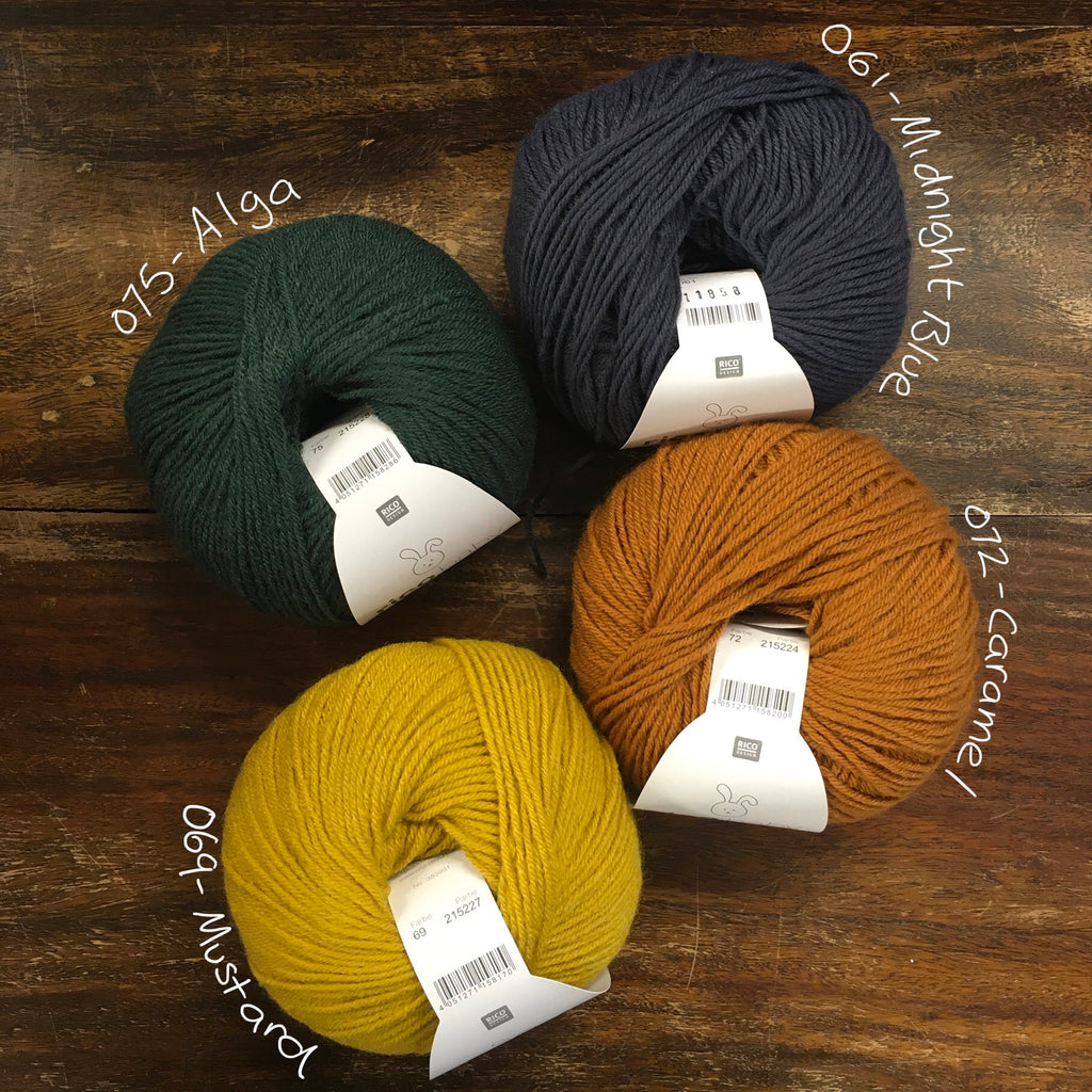 4 balls of Rico Classic Baby DK in pine green, mustard, navy and caramel orange