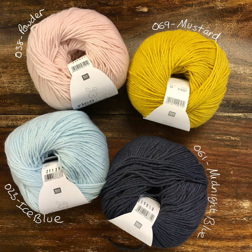 4 balls of Rico Baby Classic DK wool in pale pink, mustard, baby blue and navy