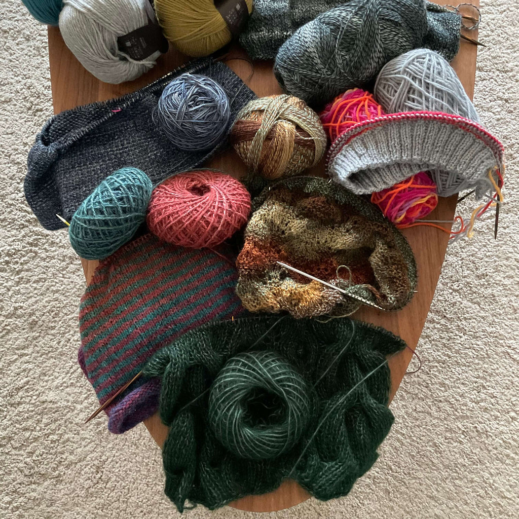 unfinished knitting projects on table