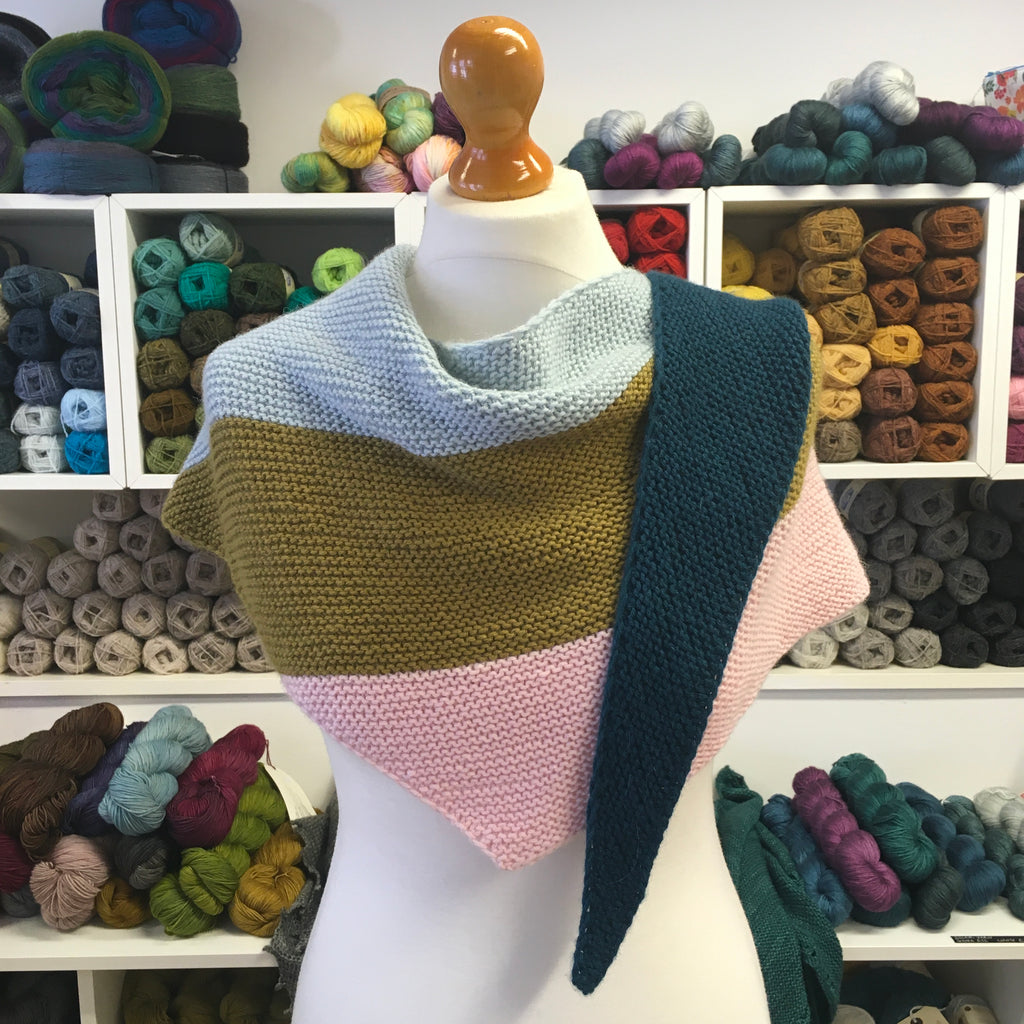 long triangle scarf wrapped around a mannequin