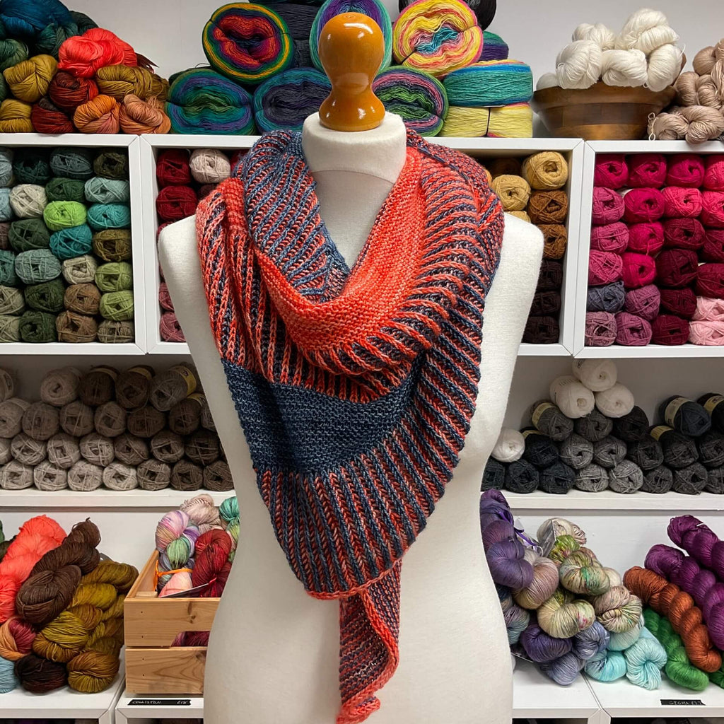 orange and blue shawl draped