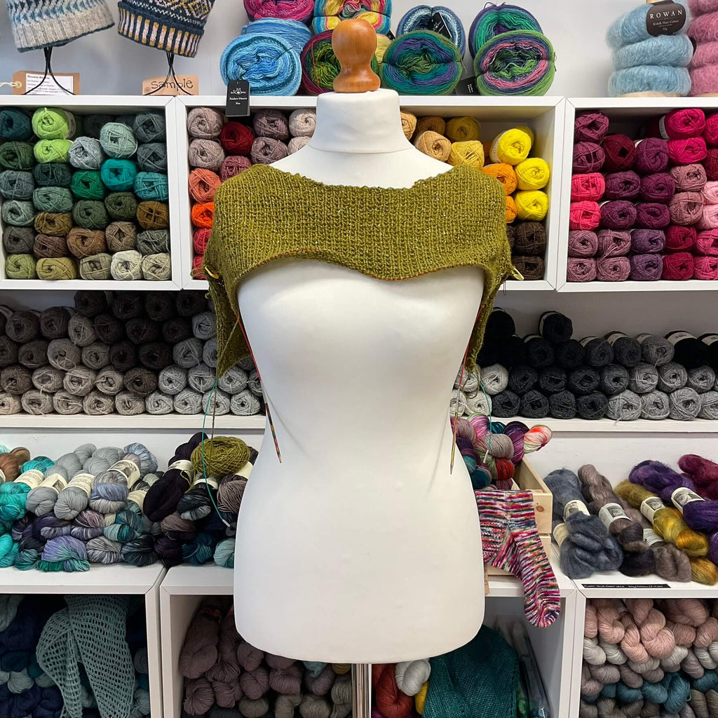 yellowy green half knitted top on a mannequin 
